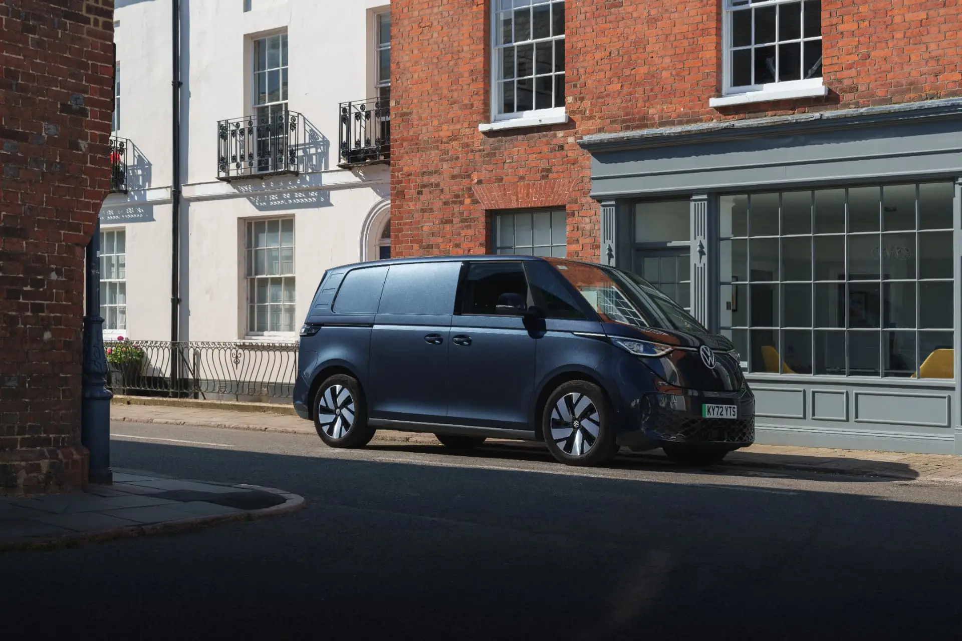 Dark blue Volkswagen ID. Buzz Cargo parked on a sunlit town street